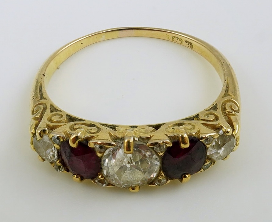 A late Victorian 18ct gold, two stone ruby and three stone diamond set half hoop ring